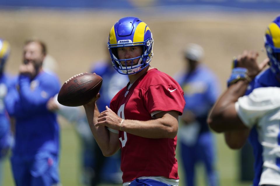 Rams quarterback Matthew Stafford fakes a pass during a June practice.