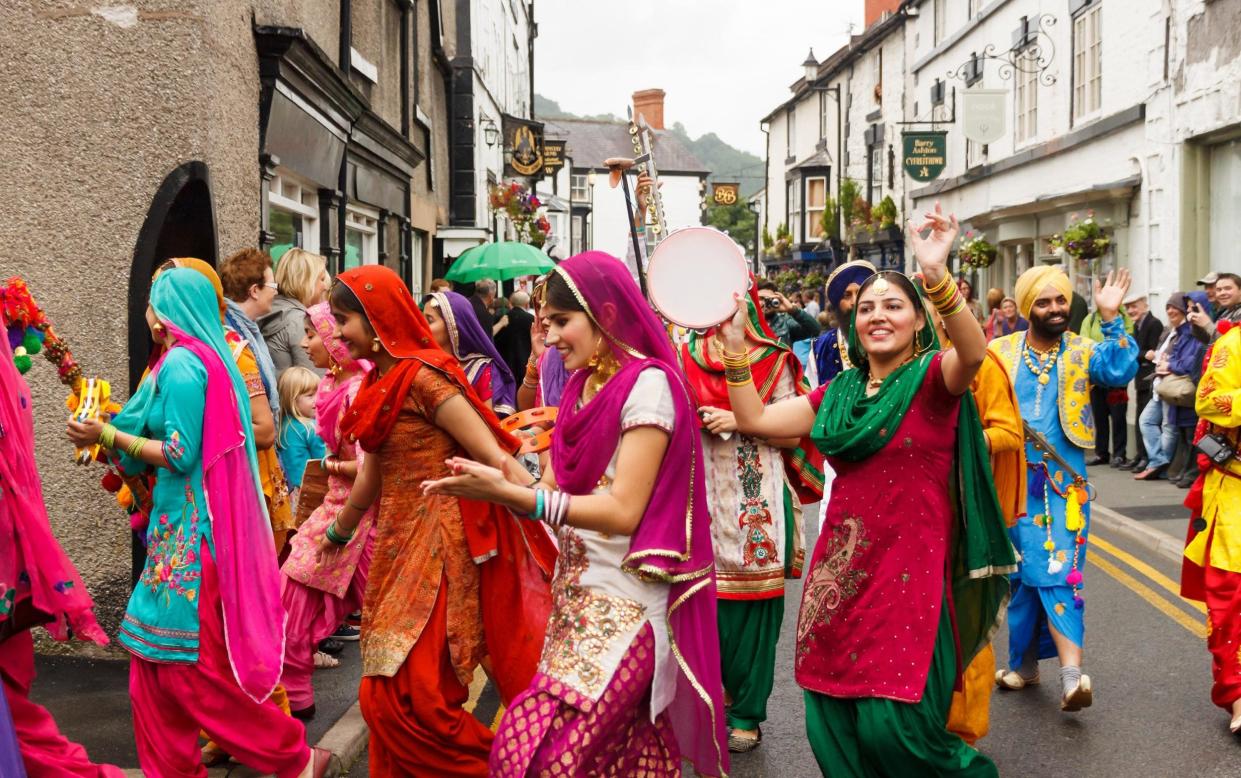 Female Indian Dancers in the annual International Eisteddfod street parade in Llangollen North Wales - Howard Pimborough / Alamy Stock Photo