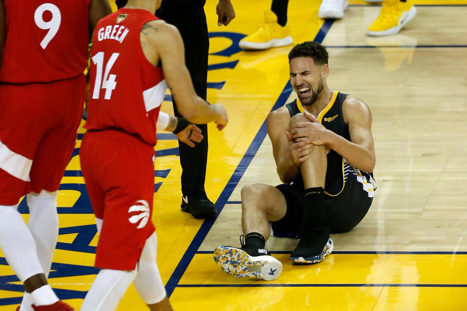 OAKLAND, CALIFORNIA - JUNE 13:  Klay Thompson #11 of the Golden State Warriors reacts after hurting his leg against the Toronto Raptors in the second half during Game Six of the 2019 NBA Finals at ORACLE Arena on June 13, 2019 in Oakland, California. NOTE TO USER: User expressly acknowledges and agrees that, by downloading and or using this photograph, User is consenting to the terms and conditions of the Getty Images License Agreement. (Photo by Lachlan Cunningham/Getty Images)