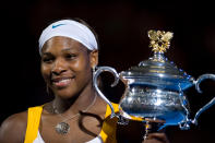 Serena Williams celebrates with the Australian open trophy after her victory against Justine Henin (Photo by EMPICS Sport - EMPICS/PA Images via Getty Images)