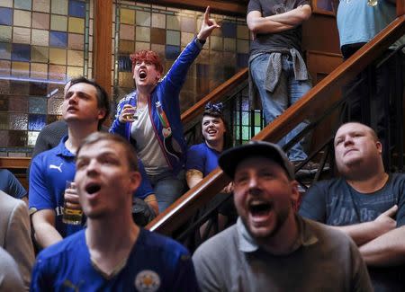 Leicester City fans react during their team's soccer match against Manchester United, as they watch the match on television in the Hogarth's pub in Leicester, Britain May 1, 2016. REUTERS/Eddie Keogh