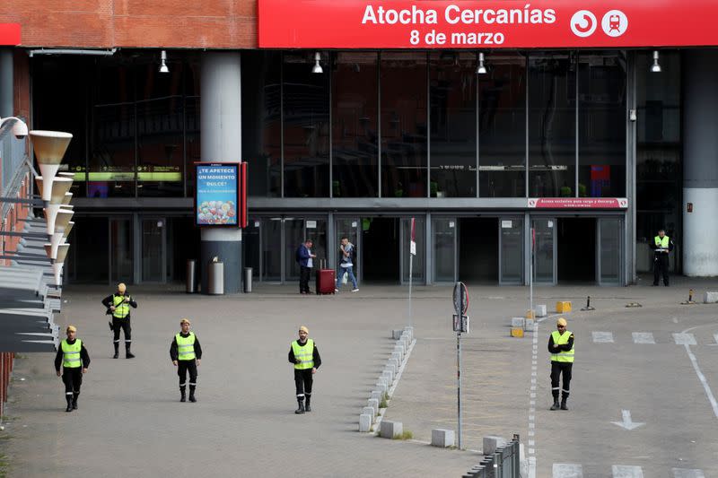 Members of the Military Emergency Unit (UME) patrol Atocha train station during partial lockdown as part of a 15-day state of emergency to combat the coronavirus (COVID-19) spread in Madrid