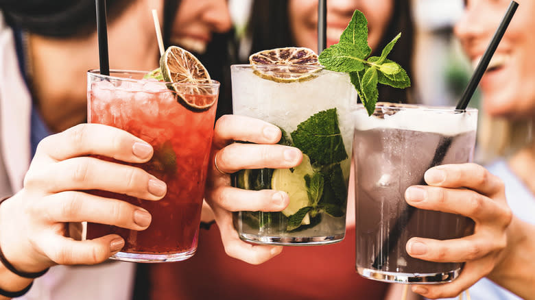 People holding iced cocktails