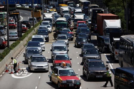 Traffic is seen as workers remove barricades that were placed by protesters to block the road, at the Cross-Harbour Tunnel in Hong Kong, China August 5, 2019. REUTERS/Eloisa Lopez