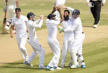 England's Moeen Ali celebrates after dismissing India's Bhuvneshwar Kumar during the third cricket test match at the Rose Bowl cricket ground, Southampton, England July 31, 2014. REUTERS/Philip Brown