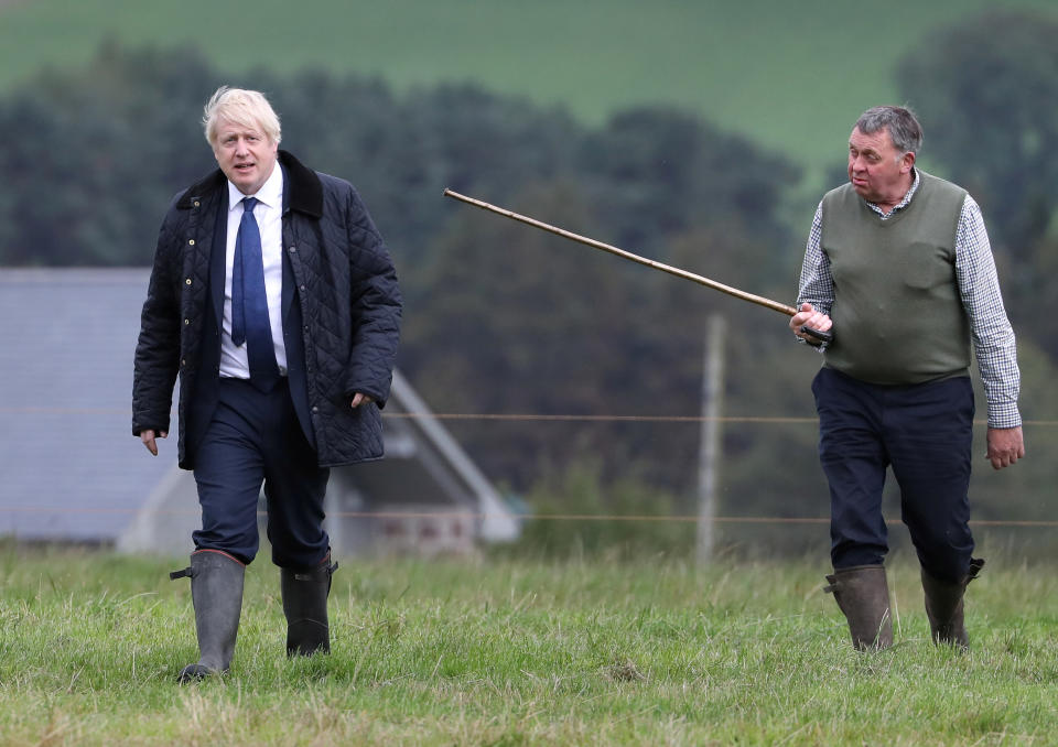 Britain's Prime Minister Boris Johnson and Farmer Peter Watson are seen during a visit at Darnford Farm in Darnford, Banchory near Aberdeen, Scotland, Britain September 6, 2019. Andrew Milligan/Pool via REUTERS