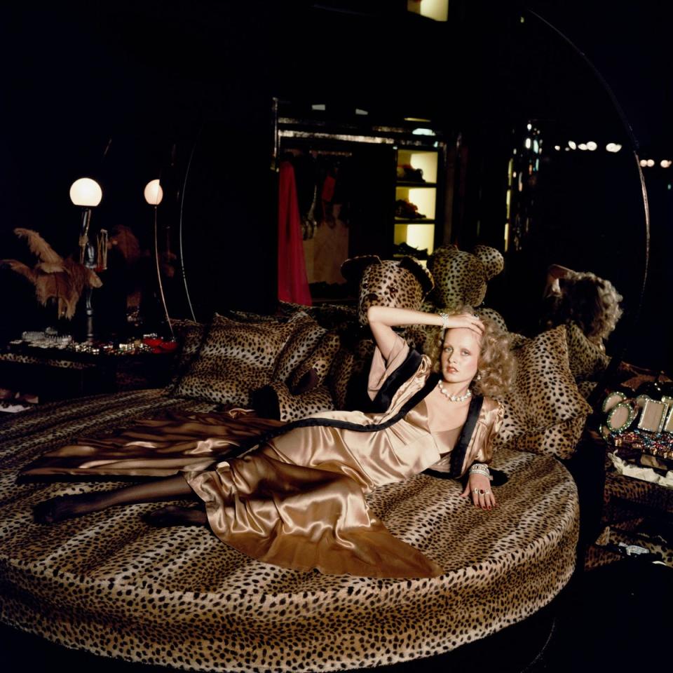  (English model Twiggy stretches out on a leopard skin bed at Biba's Kensington store, 1971. Getty Images)