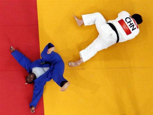 Cuba's Idalys Ortiz (L) celebrates after winning her women's 78kg semifinal judo match against China's Tong Wen at the London 2012 Olympic Games August 3, 2012.