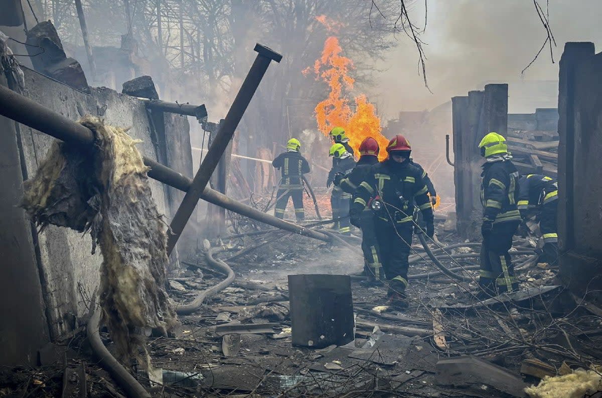 Rescuers extinguishing a fire at the site of the missile attack in Odesa on Friday (Ukrainian Emergency Service/AFP)