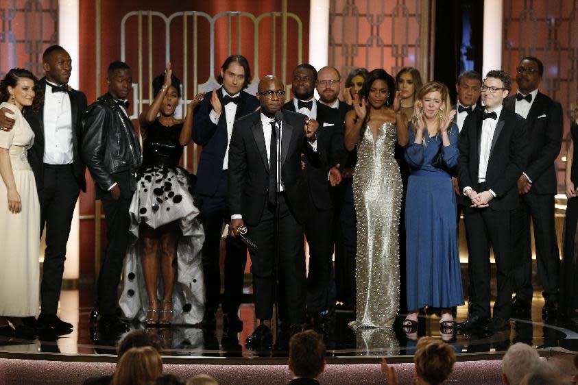 This image released by NBC shows Adele Romanski, foreground center, with the cast and crew of "Moonlight," accepting the award for best motion picture drama at the 74th Annual Golden Globe Awards at the Beverly Hilton Hotel in Beverly Hills, Calif., on Sunday, Jan. 8, 2017. (Paul Drinkwater/NBC via AP)