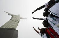 2016 Rio Olympics - Christ the Redeemer - 30/07/2016. Members of the Olympic refugee team pose in front of Christ the Redeemer. REUTERS/Kai Pfaffenbach