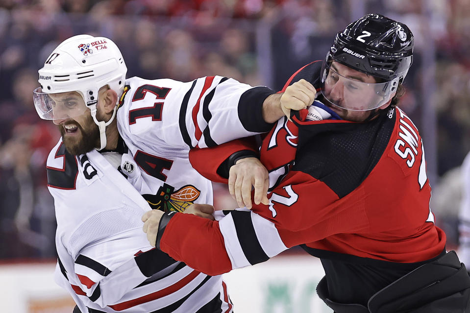 Chicago Blackhawks left wing Nick Foligno (17) fights with New Jersey Devils defenseman Brendan Smith during the second period of an NHL hockey game Friday, Jan. 5, 2024, in Newark, N.J. (AP Photo/Adam Hunger)