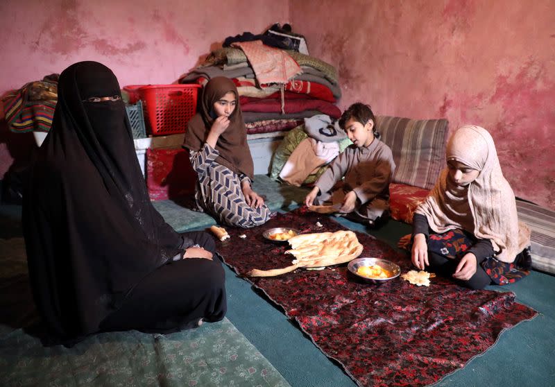 Delkhah Sultani, 30, an Afghan widow who lost her husband in a suicide attack almost six years ago, sits with her children eating their Iftar in Kabul