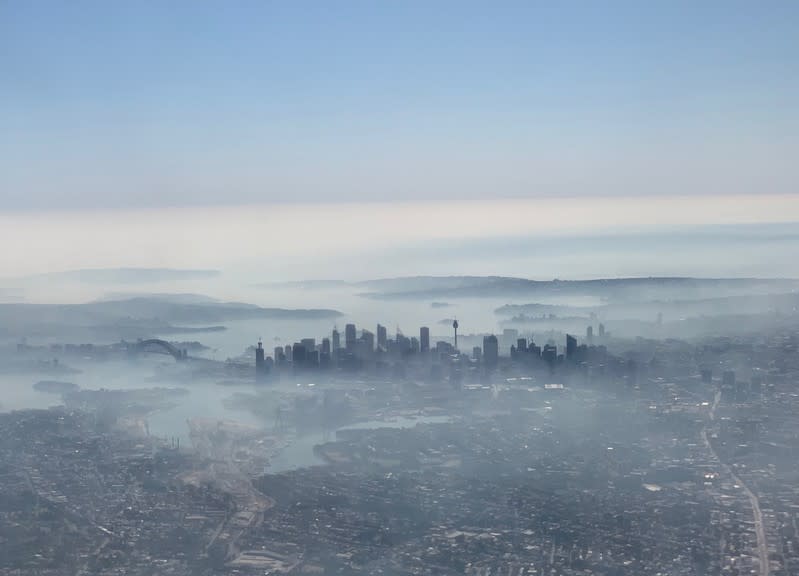 An image taken on a smart phone from a plane window shows smoke haze blanketing Sydney