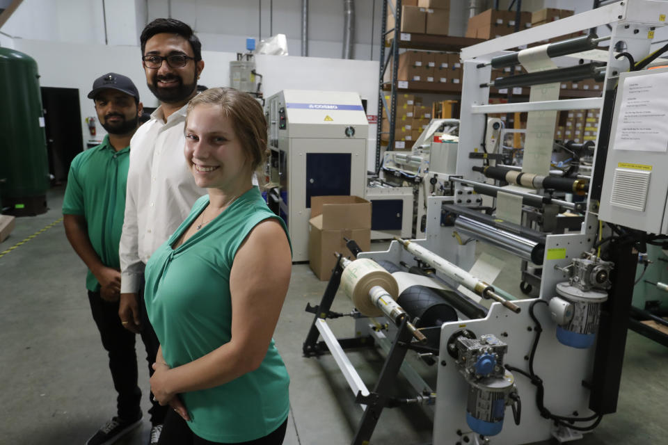 In this Friday, July 5, 2019, photo Achyut Patel, Director of Operations, Rudy Patel, Director of Business Development an Katrina Hart, business development coordinator pose for a picture at beyond Green, a maker of biodegradable bags in Lake Forest, Calif. (AP Photo/Chris Carlson)