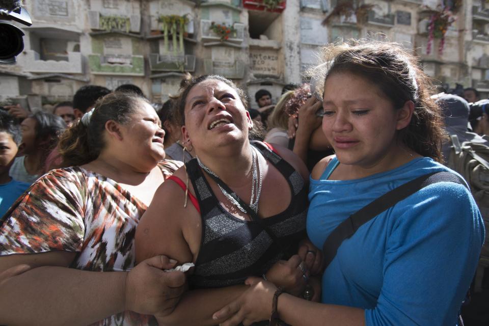 Women cry during a burial of 14-year-old Madelyn Patricia Hernandez Hernandez, a girl who died in a fire at the Virgin of the Assumption Safe Home, at the Guatemala City's cemetery, Friday, March 10, 2017. Families began burying some of the 36 girls killed in a fire at an overcrowded government-run youth shelter in Guatemala as authorities worked to determine exactly what happened. (AP Photo/Moises Castillo)