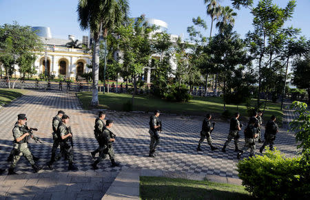 Military personnel walk outside the Paraguayan Congress building where lawmakers argue over a possible change in law that would allow President Horacio Cartes to run for re-election, in Asuncion, Paraguay March 28, 2017. REUTERS/Jorge Adorno