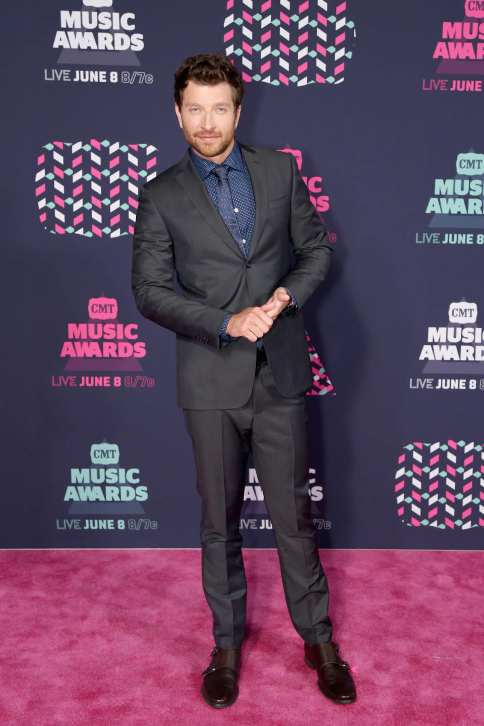 Brett Eldredge posing in a gray suit 