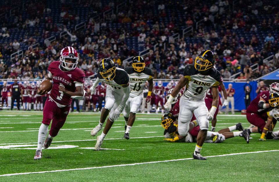 Muskegon's M'Khi Guy runs the ball against the Detroit King's defense during the first half of the Division 3 football final at Ford Field on Saturday, Nov. 26, 2022.