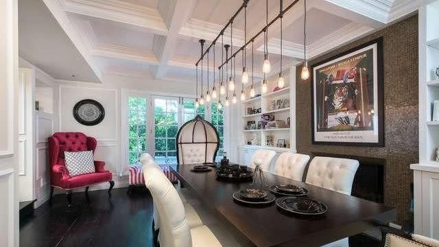 Ashley Benson's dining room with coffered ceilings, a fireplace and built-in shelving