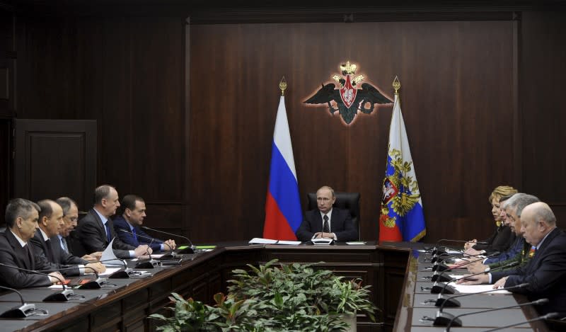 Russian President Vladimir Putin chairs a meeting with members of the Security Council at the National defence control centre in Moscow, Russia, March 11, 2016. REUTERS/Mikhail Klimentyev/Sputnik/Kremlin  