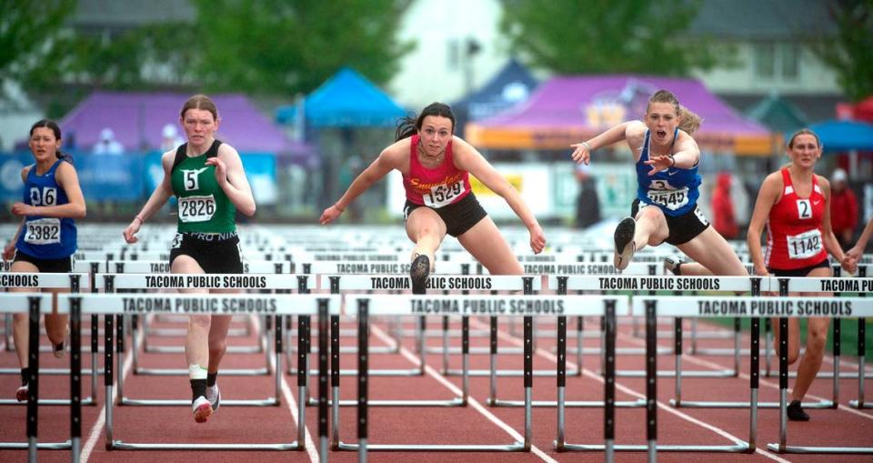 Enumclaw’s Ellie DeGroot (center) runs to a state championship in the 2A girls 100-meter hurdles during the second day of the WIAA State Track and Field Championships at Mount Tahoma High School in Tacoma, Washington on Friday, May 27, 2022.