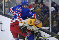 New York Rangers center Matt Rempe (73) and Boston Bruins defenseman Kevin Shattenkirk (12) slam into the boards during the second period of an NHL hockey game Thursday, March 21, 2024, in Boston. (AP Photo/Steven Senne)