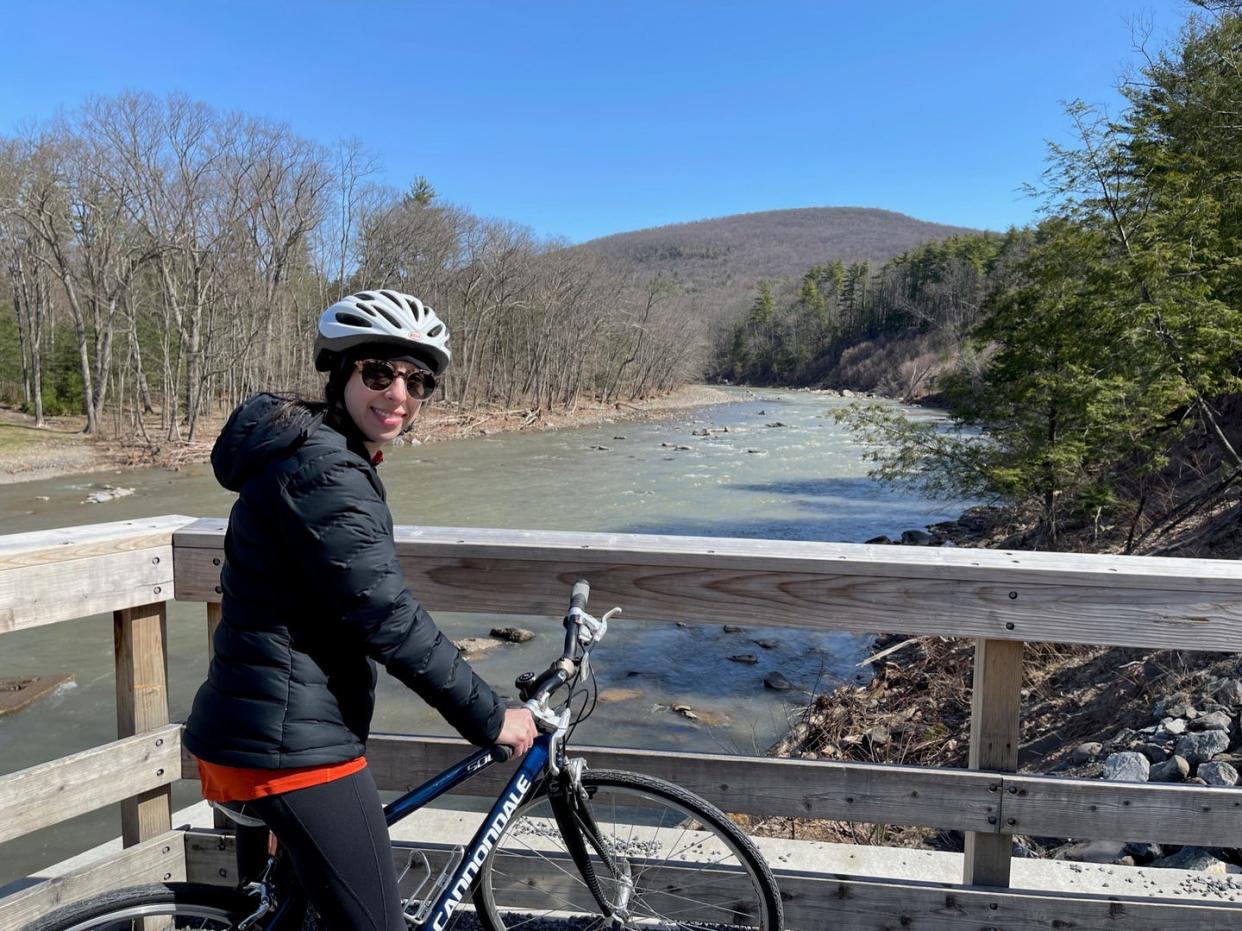 a person on a bicycle next to a river