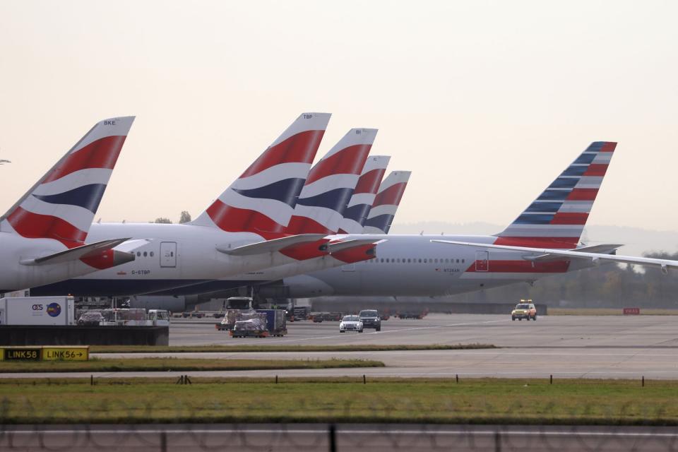 British Airways passenger aircraft and an American Airlines Group Inc. passenger aircraft outside Terminal 5 at London Heathrow Airport in London, U.K