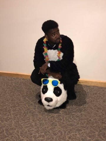Antwon Hines prepares to don the head that goes with the panda costume as part of his role as the Smithsonian National Zoo's unofficial mascot.