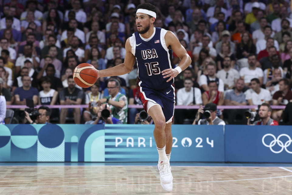 LILLE, FRANCE - JULY 28: Devin Booker #15 of Team USA dribbles the ball against during the Men's Group Phase - Group C match between Serbia and USA on Day 2 of the Olympic Games Paris 2024 at Stade Pierre Mauroy on July 28, 2024 in Lille, France. (Photo by Catherine Steenkeste/Getty Images)