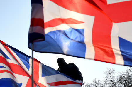FILE PHOTO: British flags fly near the Winston Churchill statue outside the Houses of Parliament during a pro-Brexit protest in London, Britain, March 29, 2019. REUTERS/Dylan Martinez