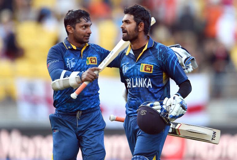 Sri Lanka's batsmen Kumar Sangakkara (L) and Lahiru Thirimanne celebrate after hitting the winning runs against England, during their Cricket World Cup Pool A match in Wellington, on March 1, 2015