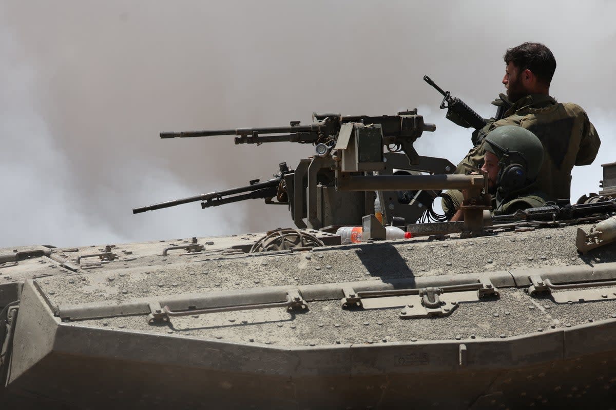 Israeli soldiers sit in a tank near the Israel-Gaza border in Israel (REUTERS)