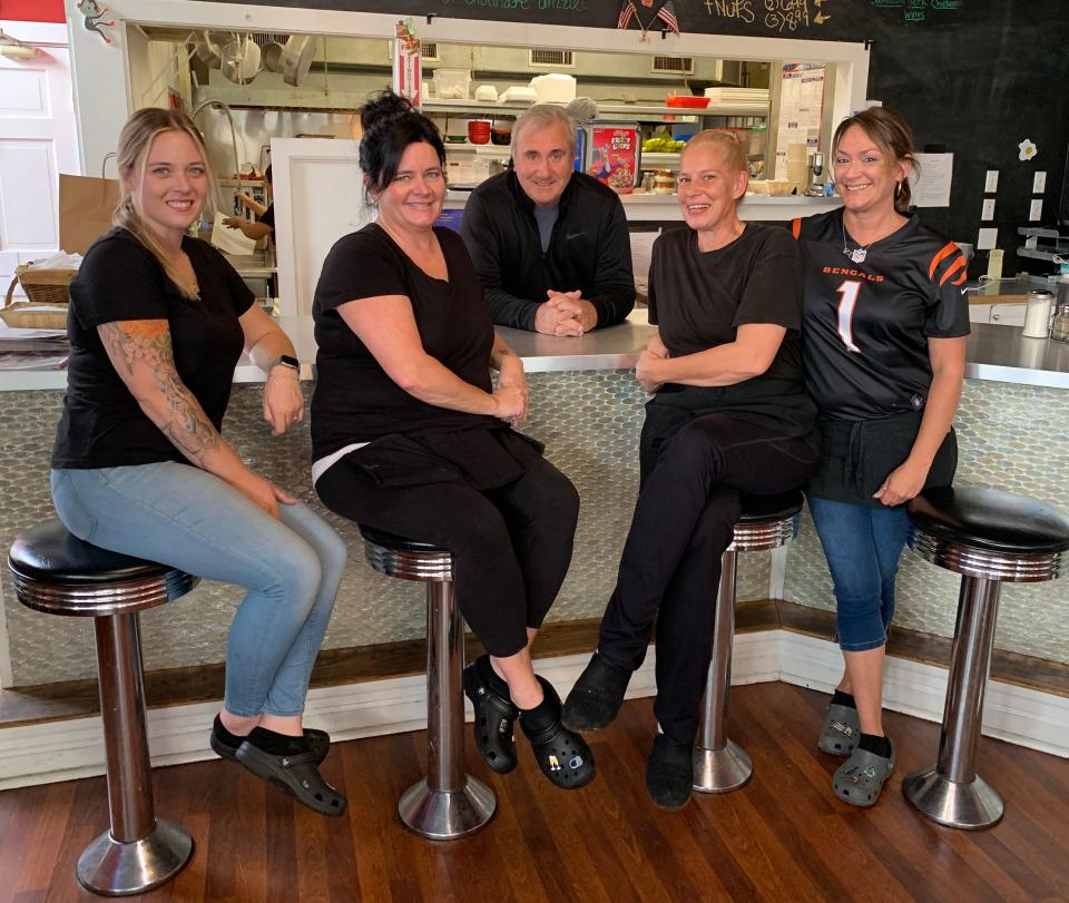 Former Bishop's 4th Street Diner employees, from left, Taylor Delehanty, Jennifer O'Loughlin, Michele White and Rebecca Bishop, are joined by Jim Quinn, owner of the Hungry Monkey restaurant on Broadway.