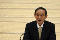 Japanese Prime Minister Yoshihide Suga declares a state of emergency for Tokyo and three other prefectures during the government task force meeting for the COVID-19 measures at the prime minister's office Friday, April 23, 2021, in Tokyo. (AP Photo/Eugene Hoshiko, Pool)