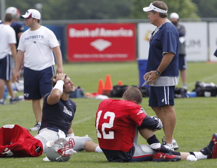 Bill Belichick lords above Tim Tebow and Tom Brady during a 2013 preseason Patriots practice. (Getty Images)