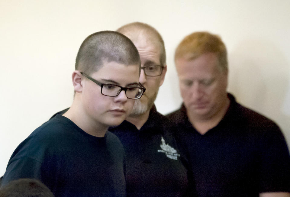 FILE - In this Sept. 27, 2017, file photo, Caleb Sharpe walks into Spokane County Juvenile Court in Spokane, Wash. A judge has ruled Tuesday, July 23, 2019, that Sharpe, 17, will be tried as an adult in a 2017 school shooting near Spokane. Sharpe is accused of opening fire in a hallway of Freeman High School, killing one classmate and wounding three others. (Kathy Plonka/The Spokesman-Review via AP, File)