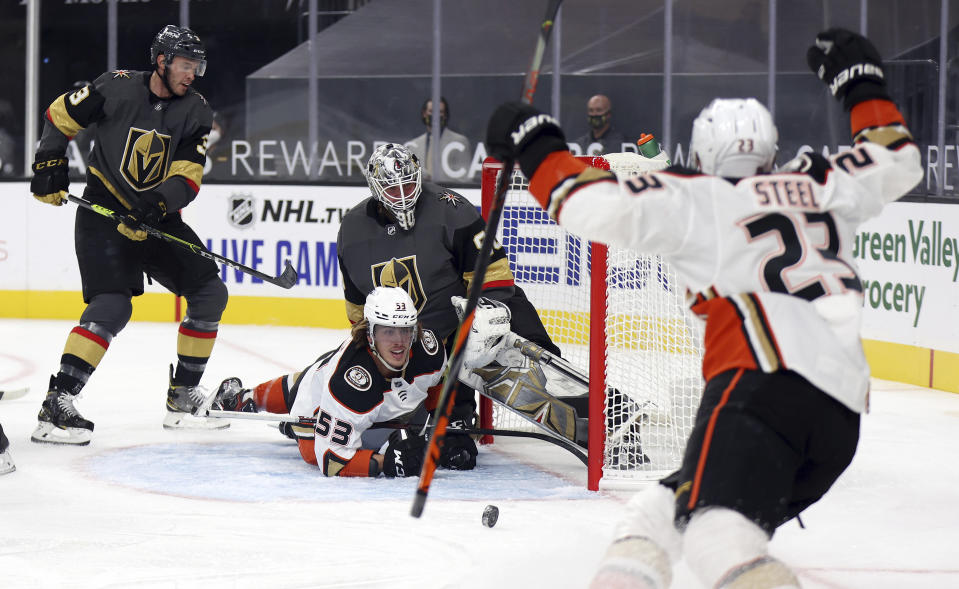 Anaheim Ducks left wing Max Comtois (53) looks up at center Sam Steel (23) after scoring against the Vegas Golden Knights during the first period of an NHL hockey game Thursday, Jan. 14, 2021, in Las Vegas. (AP Photo/Isaac Brekken)