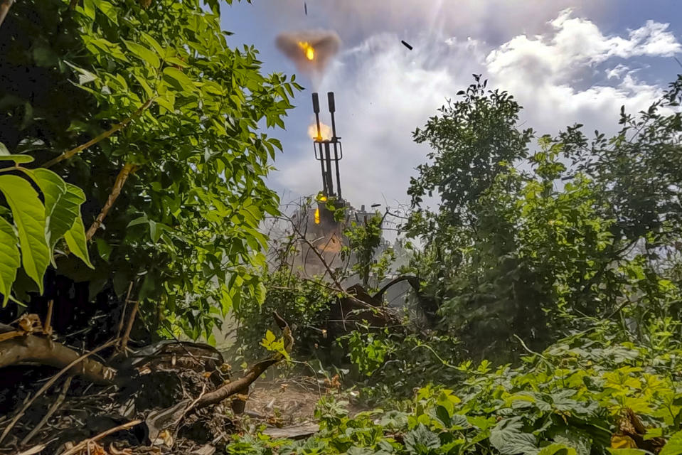 In this photo released by Russian Defense Ministry Press Service Friday, June 21, 2024, Russian soldiers fire an anti-aircraft gun at an undisclosed location in Ukraine. (Russian Defense Ministry Press Service via AP)