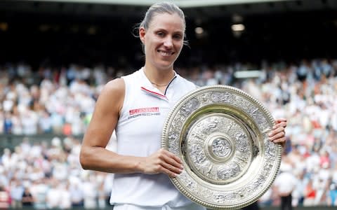 Angelique Kerber holds up her first Wimbledon trophy - Credit: Reuters