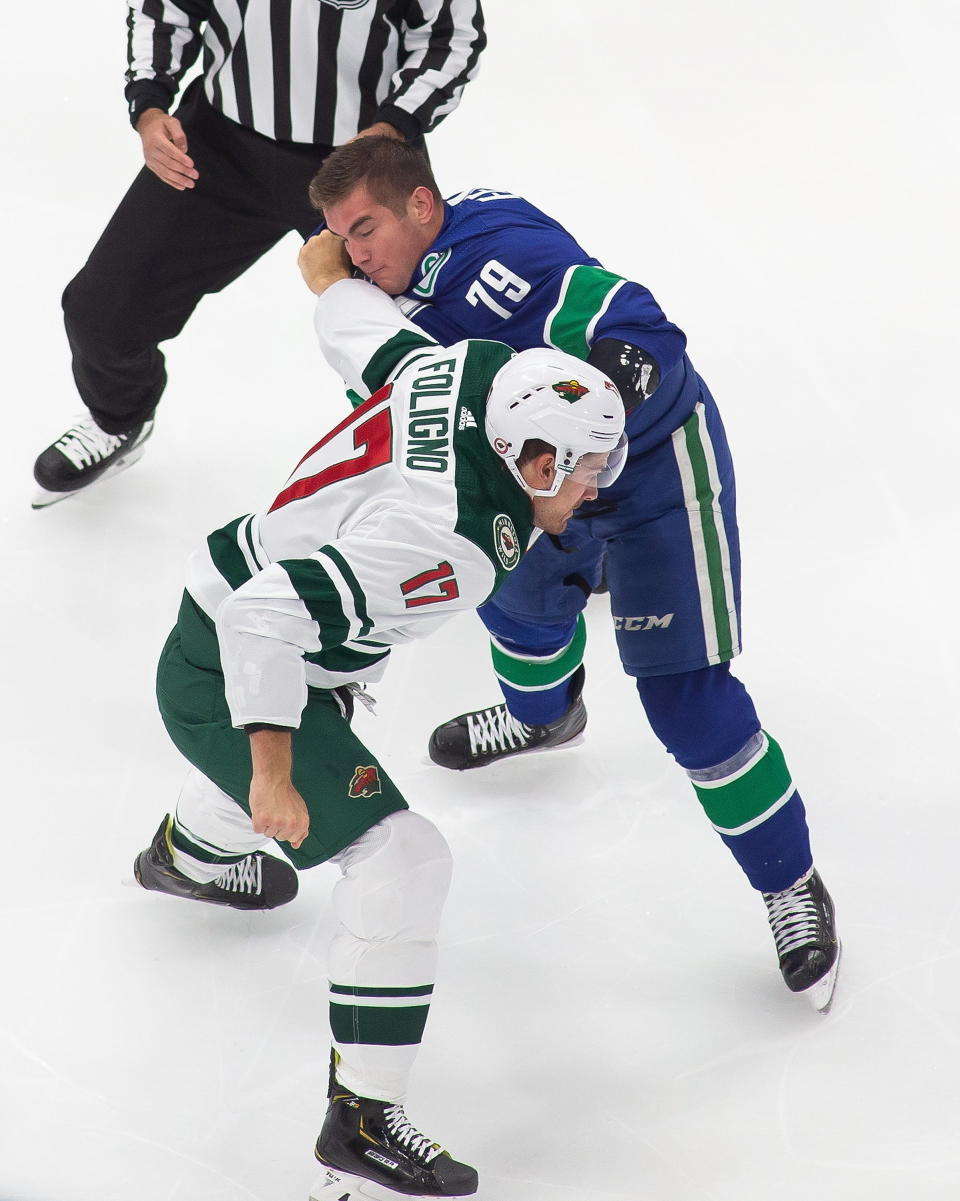 Vancouver Canucks' Micheal Ferland (79) fights Minnesota Wild's Marcus Foligno (17) during the first period of an NHL hockey playoff game Sunday, Aug. 2, 2020, in Edmonton, Alberta. (Codie McLachlan/The Canadian Press via AP)