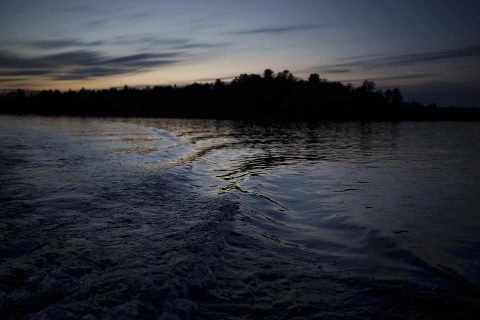 John Johnson, tribal president of the Lac du Flambeau Band of Lake Superior Chippewa Indians, leaves a wake as he drives his boat on Pokegama Lake during a youth spearfishing event Saturday, April 20, 2024, in Lac Du Flambeau, Wis. (AP Photo/John Locher)