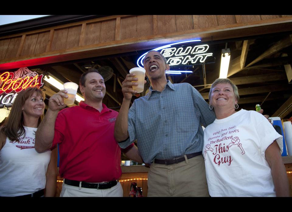 Obama has a beer with Mike Cunningham III and other workers at the beer stand at the Iowa State Fair, Monday, Aug. 13, 2012. (AP Photo/Carolyn Kaster)