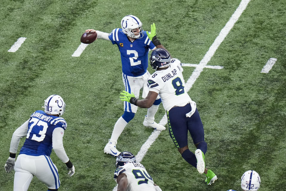 Indianapolis Colts quarterback Carson Wentz (2) is pressured by Seattle Seahawks defensive end Carlos Dunlap (8) during the second half of an NFL football game in Indianapolis, Sunday, Sept. 12, 2021. (AP Photo/AJ Mast)