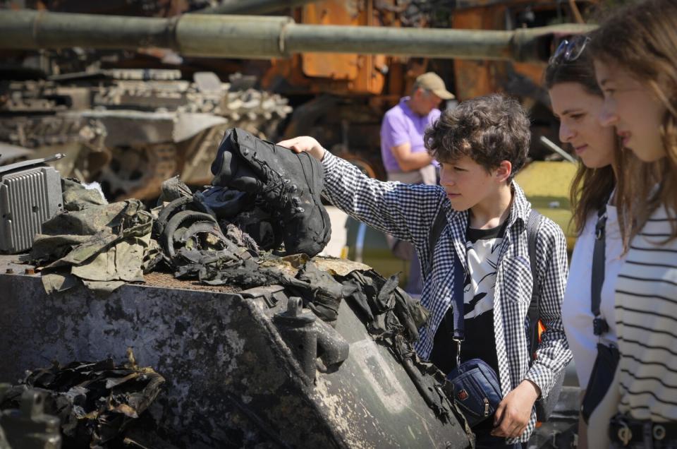 Boy holding a soldier's boot