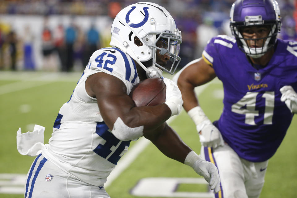 Indianapolis Colts running back Benny LeMay (42) runs from Minnesota Vikings linebacker Chazz Surratt (41) during the second half of an NFL football game, Saturday, Aug. 21, 2021, in Minneapolis. (AP Photo/Bruce Kluckhohn)