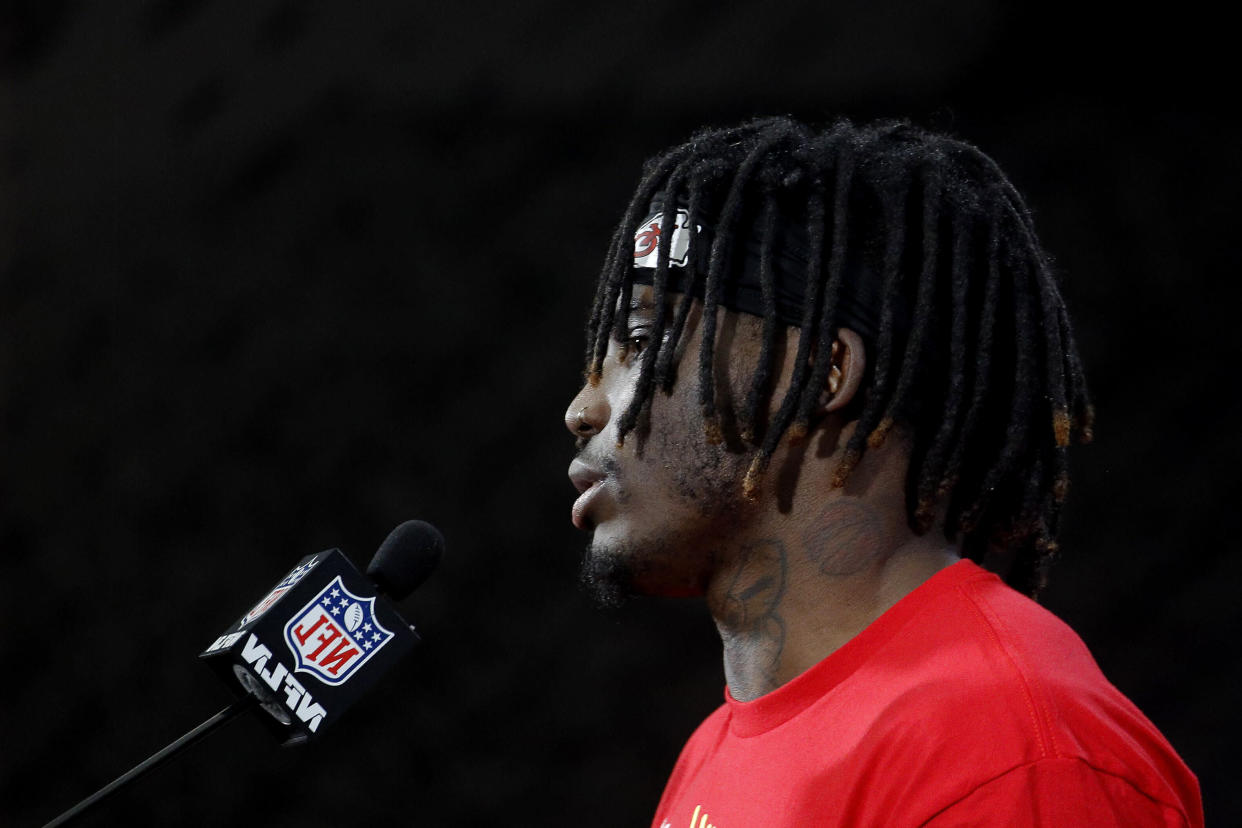 Refected in a mirror, Kansas City Chiefs wide receiver Tyreek Hill talks to the media after a workout Friday, Jan. 18, 2019, in Kansas City, Mo. The Chiefs host the New England Patriots in the NFL 's AFC football championship game on Sunday. (AP Photo/Charlie Riedel)