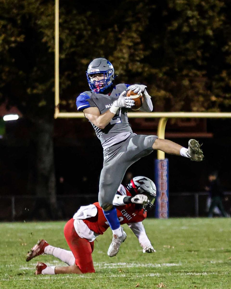 Falcon cornerback Owen Chernich (2) leaps in front of Derek Infante (2) to make the INT and then returns it down the sideline for another Cedar Crest TD. The Lebanon Cedars played host to the Cedar Crest Falcons in the 50th Annual Cedar Bowl, Friday October 28, 2022 at Alumni Stadium. Cedar Crest won the game, 47-0.