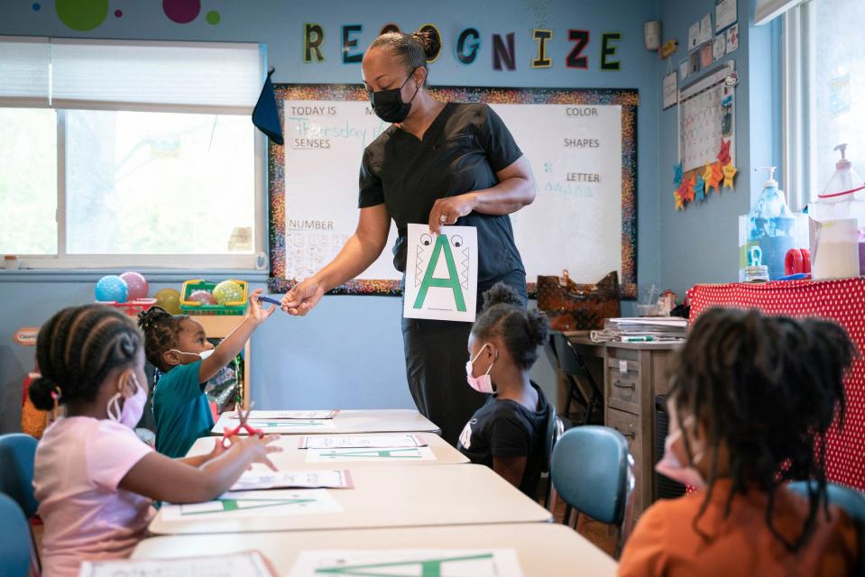 Child care provider Kitty Nixon, 53, teaches a learning activity to children at Angels of Essence Child Care Centre, a 24-hour child care facility, in Detroit on Thursday, July 14, 2022. 